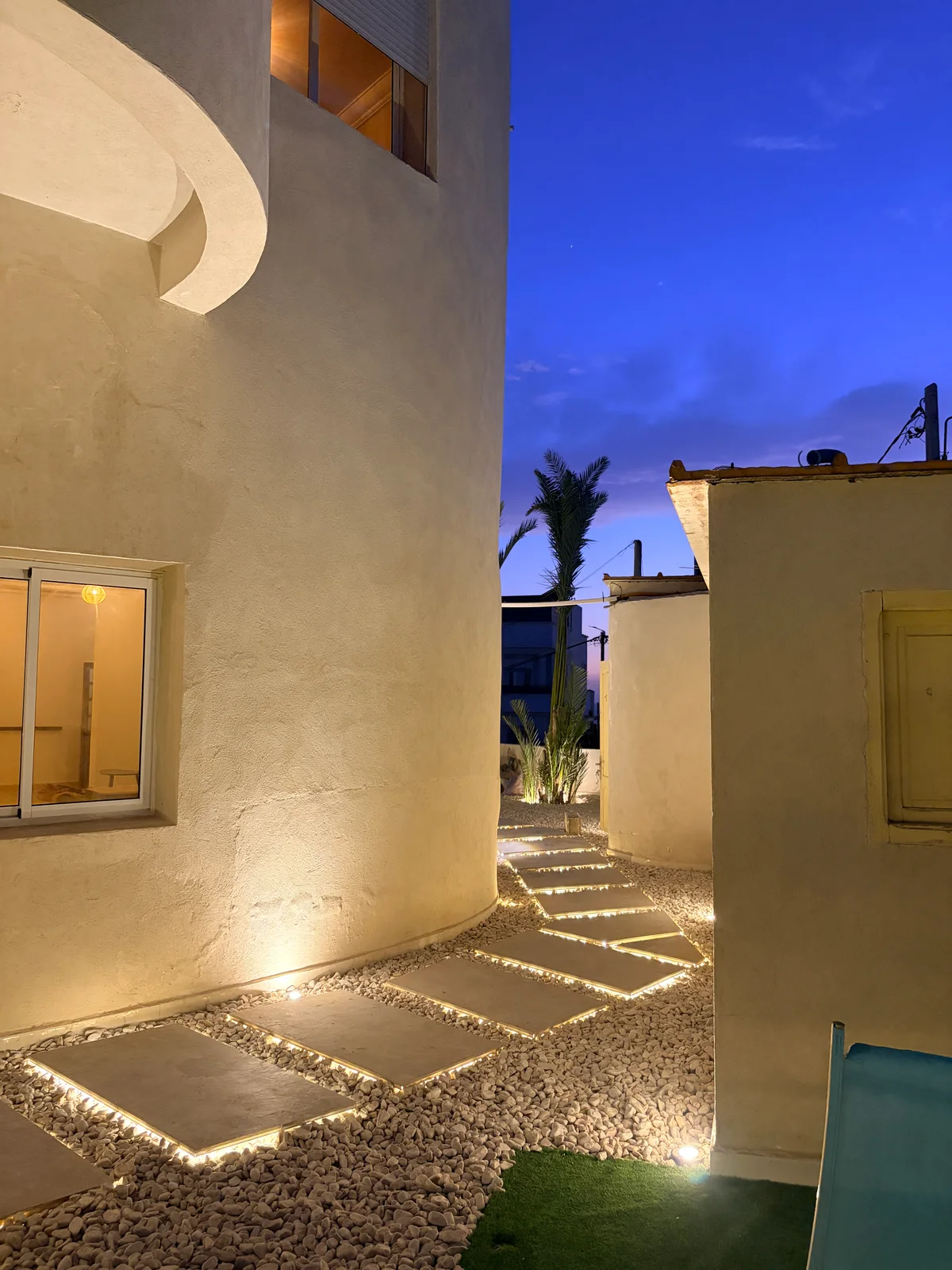 The garden steps · lit at dusk